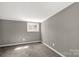 Minimalist bedroom with soft carpet, gray walls, white trim, and a bright window at 428 Chester St, Lancaster, SC 29720