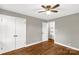 Bedroom with hardwood floors, a closet, grey walls, white trim, and a ceiling fan at 428 Chester St, Lancaster, SC 29720