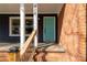 Inviting covered front porch with brick stairs and a turquoise-colored front door at 428 Chester St, Lancaster, SC 29720