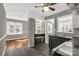 Open concept kitchen with gray cabinetry, stainless appliances, wood flooring, and attached dining area at 428 Chester St, Lancaster, SC 29720