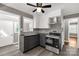 Updated kitchen with stainless steel appliances, a ceiling fan, and white and gray cabinets at 428 Chester St, Lancaster, SC 29720