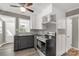 Cozy kitchen with stainless steel oven, wood floor, and gray painted paneling with white cabinets at 428 Chester St, Lancaster, SC 29720