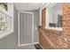 Laundry room nook with brick exterior and folding door at 428 Chester St, Lancaster, SC 29720
