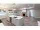 View of the living room and kitchen featuring a fireplace, white cabinets, and oversized island at 4531 Deer Run None, Rock Hill, SC 29732