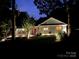 Charming single-story home with a vibrant red door, welcoming curb appeal, and cozy porch lighting at 5091 Windward Dr, Tega Cay, SC 29708