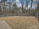 Large, fenced backyard with mature trees and a grassy lawn at 5091 Windward Dr, Tega Cay, SC 29708
