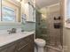 Bathroom with a modern vanity, glass-enclosed shower, and stylish fixtures at 5091 Windward Dr, Tega Cay, SC 29708