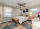 Bright bedroom with a ceiling fan, windows, and an area rug at 5091 Windward Dr, Tega Cay, SC 29708