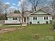 Charming home featuring a red front door, inviting porch, and well-manicured lawn at 5091 Windward Dr, Tega Cay, SC 29708
