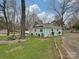 Landscaped yard showcasing the home's exterior with mature trees and a well-maintained lawn at 5091 Windward Dr, Tega Cay, SC 29708