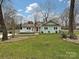 Inviting light blue home featuring a cozy front porch, well-maintained lawn, and attractive landscaping at 5091 Windward Dr, Tega Cay, SC 29708