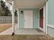 Front entrance with a covered porch and a red door at 5091 Windward Dr, Tega Cay, SC 29708