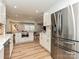 Spacious kitchen with stainless steel appliances, white cabinets, and an open floor plan to living spaces at 5091 Windward Dr, Tega Cay, SC 29708