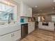 Bright kitchen featuring a large basin sink, stainless steel dishwasher and an open layout at 5091 Windward Dr, Tega Cay, SC 29708