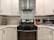 Modern kitchen featuring stainless steel appliances, a sleek range hood, and stylish backsplash at 5091 Windward Dr, Tega Cay, SC 29708