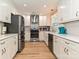 Updated kitchen with stainless appliances, stylish cabinets, and hardwood floors at 5091 Windward Dr, Tega Cay, SC 29708