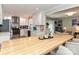 Modern kitchen featuring white cabinets, stainless steel appliances, and a large center island at 5091 Windward Dr, Tega Cay, SC 29708