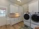 This laundry room boasts ample storage, modern machines, and a sleek design at 5091 Windward Dr, Tega Cay, SC 29708