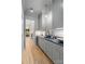This wet bar features gray cabinets, gold hardware, and a stylish globe pendant light for an elegant look at 5124 Lansing Dr, Charlotte, NC 28270