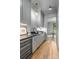 Chic bar area featuring gray cabinetry, elegant lighting, wine fridge, and wood flooring at 5124 Lansing Dr, Charlotte, NC 28270