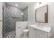 Bathroom features shower with checkered tile and a white vanity with a framed mirror at 5124 Lansing Dr, Charlotte, NC 28270