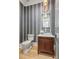 Powder room features unique patterned wallpaper, stylish vanity, and elegant light fixture at 5124 Lansing Dr, Charlotte, NC 28270