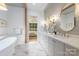 Luxurious bathroom with marble floors, double vanity, soaking tub, and modern fixtures at 5124 Lansing Dr, Charlotte, NC 28270