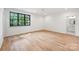 Airy bedroom with hardwood floors, a large window, and easy access to an attached bathroom at 5124 Lansing Dr, Charlotte, NC 28270