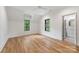 Bright bedroom with hardwood floors, black framed windows, and an ensuite bathroom at 5124 Lansing Dr, Charlotte, NC 28270