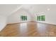 Bright bedroom boasts hardwood floors, vaulted ceilings, and large windows offering natural light at 5124 Lansing Dr, Charlotte, NC 28270
