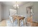 Charming dining room with wood table, gray paneled walls, modern chandelier, and hardwood flooring at 5124 Lansing Dr, Charlotte, NC 28270