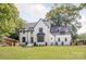 Stunning white painted brick home featuring black-trimmed windows and a perfectly manicured front lawn at 5124 Lansing Dr, Charlotte, NC 28270