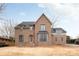 Elegant brick home featuring black framed windows, a charming arched entryway, and a classic gabled roof design at 5124 Lansing Dr, Charlotte, NC 28270