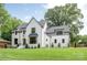 Beautiful white brick two-story home with well-kept lawn and professional landscaping at 5124 Lansing Dr, Charlotte, NC 28270