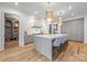 This kitchen boasts an island with seating, stainless appliances, and an open layout into the living spaces at 5124 Lansing Dr, Charlotte, NC 28270
