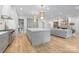 Spacious kitchen featuring a large center island with marble countertops, brass hardware, and stainless appliances at 5124 Lansing Dr, Charlotte, NC 28270