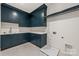 Laundry room features blue cabinets, white countertops, and modern appliances hookups at 5124 Lansing Dr, Charlotte, NC 28270