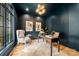 Stylish home office with dark walls, unique lighting, large window, and comfortable seating at 5124 Lansing Dr, Charlotte, NC 28270