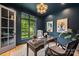 Sophisticated home office featuring dark walls, wood floors, and a bright window with a green view at 5124 Lansing Dr, Charlotte, NC 28270