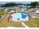 Aerial view of community pool featuring blue umbrellas, seating, and tanning ledges at 5367 Heartwood Ln, Denver, NC 28037