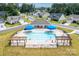 Aerial view of neighborhood pool with blue umbrellas and a playset at 5367 Heartwood Ln, Denver, NC 28037