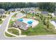Aerial view of the neighborhood pool with blue umbrellas and a playset at 5367 Heartwood Ln, Denver, NC 28037