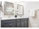 Bathroom with double vanity, modern fixtures, and white floral decor at 5367 Heartwood Ln, Denver, NC 28037