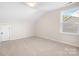 Bright bedroom with neutral carpet, a window view, and ample space, creating a comfortable and inviting atmosphere at 5367 Heartwood Ln, Denver, NC 28037