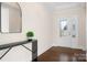 Entryway featuring a dark wood floor, white trim, console table, and modern mirror at 5367 Heartwood Ln, Denver, NC 28037