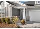 Home's inviting entrance with stone accents on siding and columns along with a well manicured garden at 5367 Heartwood Ln, Denver, NC 28037