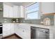 Bright kitchen with a farmhouse sink, stainless steel dishwasher, and ample white cabinetry at 5367 Heartwood Ln, Denver, NC 28037