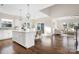 Open-concept kitchen featuring an island, stainless appliances, hardwood floors, and lots of natural light at 5367 Heartwood Ln, Denver, NC 28037