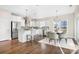 Beautiful kitchen featuring an island with barstool seating, white cabinets, and stainless steel appliances at 5367 Heartwood Ln, Denver, NC 28037