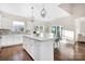 Modern kitchen featuring an island, white cabinets, stainless steel appliances, and a dining area at 5367 Heartwood Ln, Denver, NC 28037